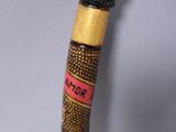 a wooden stick with a stick handle that has a flower design on it