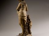 statue of a woman with a dog on a pedestal