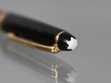 a black pen with a white star on it sitting on a table