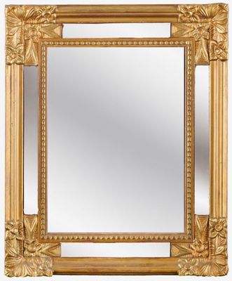 a gold framed mirror on a white background