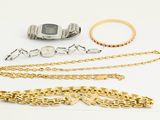 a lot of gold and silver jewelry on a white surface