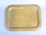 a gold tray with a decorative design on it