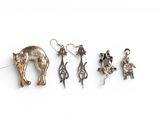 several different types of earrings are shown on a white surface