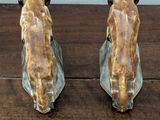 two figurines of giraffes sitting on a wooden table