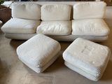 a white couch and ottoman in a living room