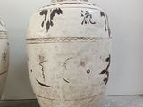 two large vases sitting next to each other on the floor