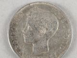 a close up of a silver coin with a woman ' s head on it