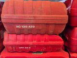 many red boxes stacked on top of each other on a shelf