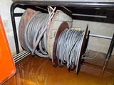 a spool of wires on a rack in a room