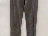 a pair of brown leather pants hanging on a hanger