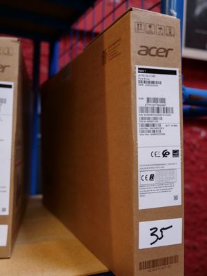 two boxes of acer products sit on a shelf in a store