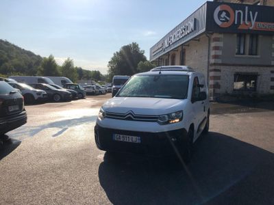 citroen van parked in front of a building in a parking lot