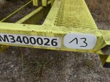 a close up of a yellow metal rail with a number on it