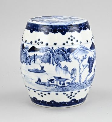 a blue and white vase with a landscape on it