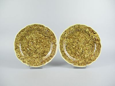 a pair of yellow and white plates on a white background