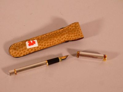 two pens and a pen case sitting on a table