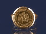 l'image d'un anneau d'or surmonté d'une pièce de monnaie
