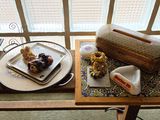 two plates of food sitting on a table with a window in the background