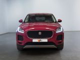 the front view of a red jaguar suv parked in a showroom