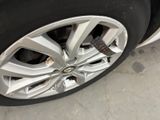 a close up of a tire on a car in a garage
