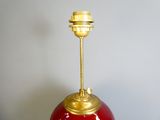 an image of a red and gold lamp on a table