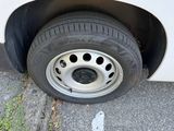 a tire on the side of a white car