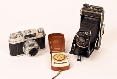 three different types of cameras on a white surface