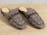 a pair of brown shoes on a wooden surface