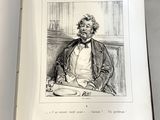 un livre ouvert sur lequel figure le dessin d'un homme assis à une table