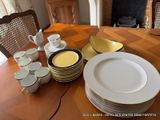 a lot of plates and cups on the table