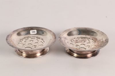 pair of silverplated dishes on stands on a white surface