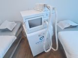 two small beds in a small room with a microwave on top of them