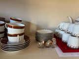 many cups and saucers sitting on a table