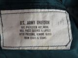 an army uniform label on the back of a green jacket