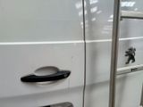 a ladder that is leaning against the side of a white van