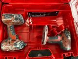 a red tool box with two tools inside of it