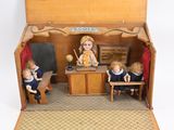 a small doll house with a teacher and two children in it