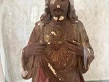 a statue of jesus in a glass jar on a table