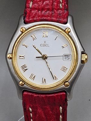 an image of a close up of a wrist watch with roman numerals