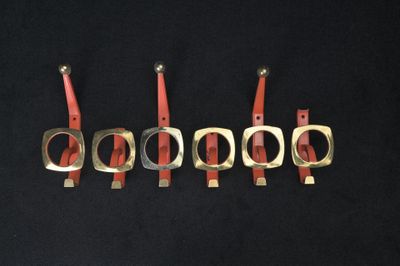 six pairs of scissors are lined up in a row on a black surface