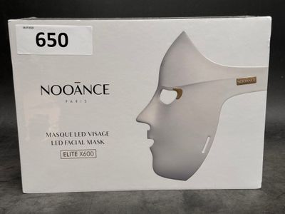 a box with a white mask on it on a table