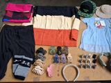 a table with a lot of clothing and accessories on it