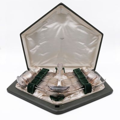 silverware in a black case with green handles and spoons in it