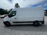 a white van parked in a parking lot under a cloudy sky