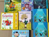 several children ' s books are lined up on the floor