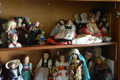 many dolls on the shelves in the room