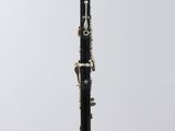 a close up of a black and white clarinet on a clear surface
