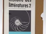 an open book sitting on top of a cardboard box on a white surface