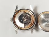an image of a close up of a watch on a white surface