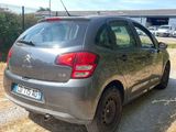 the car is parked on the side of the road in the dirt